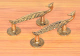 Brass peacock door handles with flared finial knobs and round backplates