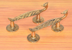 Brass peacock door handles with flared finial knobs and round backplates