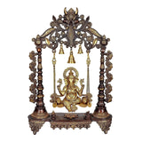 Brown brass Ganesha swing with ornate arch, hanging bells and seated Ganesha figurine