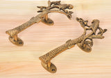 Brass parrot tree door handles, pair viewed at an angle with leaf and bird details
