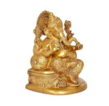 Brass Ganesha idol statue, seated on base with one hand raised, angled view