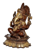 Side view brass Ganesha sculpture in brown and gold, seated with two arms up