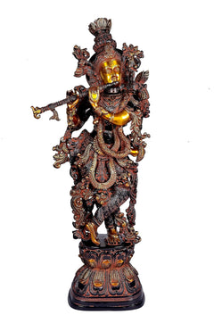 Brass Lord Krishna statue in standing pose, ornate sculpted detailing and pedestal base