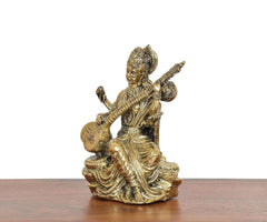 Brass Maa Saraswati statue, three-quarter view, veena across lap on lotus base