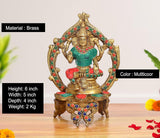 Brass Lakshmi idol with jeweled arch, teal outfit, multicolor details, decorated base