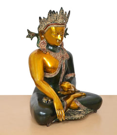 Brass Buddha statue in bhumisparsha mudra, golden left arm and dark green body