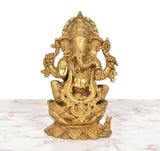 Golden brass Ganesha sitting on lotus, front view with ornate crown
