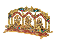 Gold-tone Ganesh, Laxmi, Saraswati metal idol with red base and peacock arch