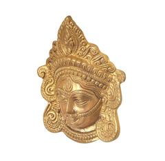 Gold-tone brass Durga face idol close-up, angled view showing crown details