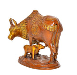 Brass cow and calf decorative statue, rear three-quarter view, textured patterned base
