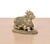 Brass seated Nandi statue side view, carved torso and layered decorative trim