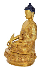 Side view of gold Buddha statue idol with blue jeweled crown and meditating hands