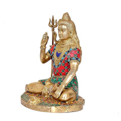 Brass Lord Shiva side view, trident raised; gold face with red-green jeweled robe