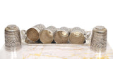 Side view: tray holding six empty silver-toned glasses
