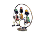 Three iron musical men figurines with colorful outfits and circular metal ring