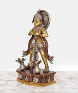 Brass Hanuman murti side view with flowing drape, gold face, and pedestal side carvings