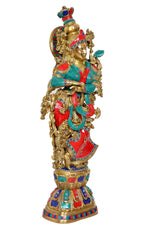 Brass Radha idol statue holding curved emblem, red and teal garments with gold ornaments