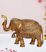 Brass elephant figurine with detailed patterned body and raised trunk, decorative home statue