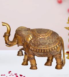 Brass elephant figurine with detailed patterned body and raised trunk, decorative home statue