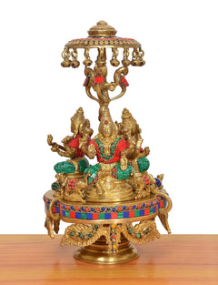 Lakshmi-Ganesha-Saraswati brass idol on round moving base with parasol, multicolor