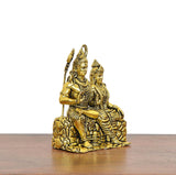 Golden brass Shiva and Parvati idol, side view, seated on textured rocky lotus base
