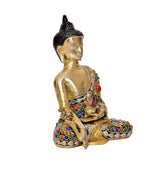 Brass Buddha statue with black ushnisha and colorful jeweled robe, seated