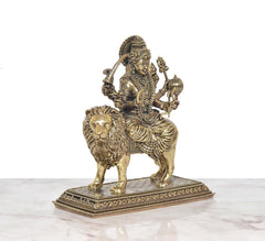 Durga Maa statue on lion, angled view showing lion face and textured mane
