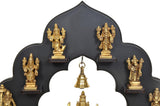 Close-up of brass Dashavatara idol frame with golden statues and hanging bell
