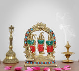 Brass Darbar idol, arched frame with three standing figures, multicolor accents