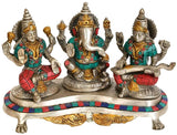 Brass Ganesh-Lakshmi-Saraswati idol trio, detailed faces and raised hands on pedestal