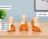 Orange resin monk Buddha figurines, seated poses; 5 inch height