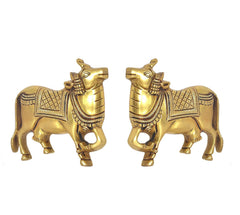 Gold-tone cow pair figurines with detailed headgear and patterned body panels