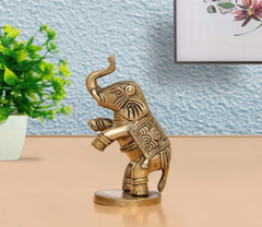 Brass elephant figurine, 4 in, gold tone, ornate armor details, raised trunk