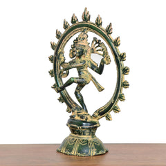 Side view of Lord Shiva dancing brass statue with green patina and arched halo ring