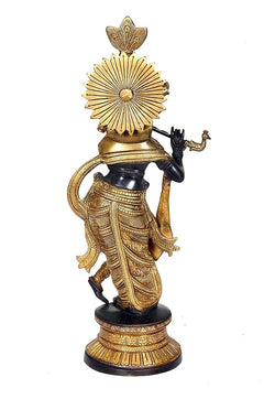Back/side view of Krishna flute-playing statue, gold radiant disc headdress, round base