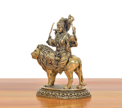 Brass Durga Maa idol on lion, side view with crown, jewelry details, and weapons