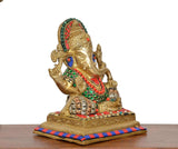 Side view Ganesha idol with multicolour bead garland and striped platform base