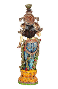 Krishna resin figurine, rear view showing detailed hair, crown, and multicolored clothing
