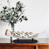 Resin tusk showpiece with seven running horse sculptures, white finish, black base.
