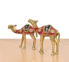 Brass camel figurines facing each other, red and navy saddle with gold trim