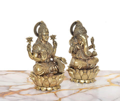 Angled view of brass Lakshmi & Ganesha statue set (7 in), raised hands and halos
