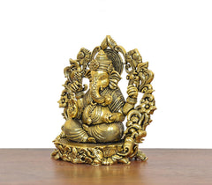 Golden brass Ganesha idol front view, seated four-armed figure with crown halo