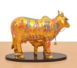Resin Kamdhenu cow and calf with patterned back, hanging chain bell accessory.