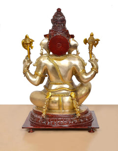 Brass Ganpati Bappa idol back view, gold torso with red circular emblem and red crown