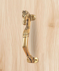 Brass horse-shaped door handle with curved lever and round fixing points