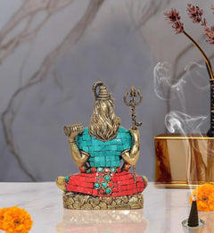 Brass Shiva idol sculpture rear view, turquoise robe with red belt and bead trim