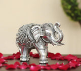 Silver elephant figurine, 3-inch height, close-up profile with engraved headgear.