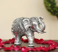Silver elephant figurine, 3-inch height, close-up profile with engraved headgear.