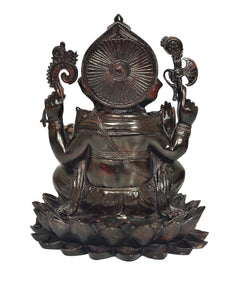 Back view of Brass Ganesha seated on lotus, ornate halo and raised hands