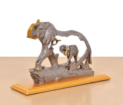 Gray resin elephant and baby elephant figurine, side view on gold base
